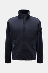 Front view of Stone Island Jacket 'Light Soft Shell-R' navy, a slim fit soft shell with standing collar, two-way zip, flap pockets, elastic cuffs, and compass badge.

<p>Style meets function: This soft shell jacket by STONE ISLAND has a sporty design in a