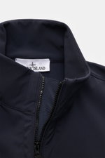 Close-up front view of Stone Island Jacket 'Light Soft Shell-R' navy showing the standing collar, two-way zip, and high-quality microfibre material.

Description: <p>Style meets function: This soft shell jacket by STONE ISLAND has a sporty design in a thr