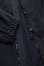 Close-up front detail of the Stone Island Jacket 'Light Soft Shell-R' navy showing the two-way zipper, elasticated cuff, and smooth fabric.

<p>Style meets function: This soft shell jacket by STONE ISLAND has a sporty design in a three-layer functional ma