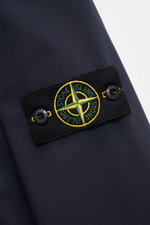 Close-up front sleeve view of Stone Island Jacket 'Light Soft Shell-R' navy showing black compass badge with yellow and green embroidery on smooth, high-quality microfibre fabric.

<p>Style meets function: This soft shell jacket by STONE ISLAND has a spor