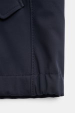 Close-up view of the hem and pocket flap on the Stone Island Jacket 'Light Soft Shell-R' navy, showcasing smooth navy microfiber fabric and elasticated cuff.

<p>Style meets function: This soft shell jacket by STONE ISLAND has a sporty design in a three-l