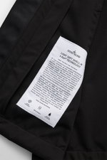 Close-up photo from above of the inner label on the Stone Island Jacket 'Light Soft Shell-R' black, showing fabric details and material information. Style meets function: This soft shell jacket by STONE ISLAND has a sporty design in a three-layer function