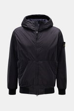 Stone Island Jacket 'Garment Dyed Crinkle Reps NY' dark navy shown from the front, lightweight microfibre with creased resin coating, padded hood, slim fit, two-way zip, zip front pockets, elastic hem and cuffs, wind and water repellent, compass badge on 