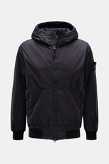 Stone Island Jacket 'Garment Dyed Crinkle Reps NY' dark navy shown from the front, lightweight microfibre with creased resin coating, padded hood, slim fit, two-way zip, zip front pockets, elastic hem and cuffs, wind and water repellent, compass badge on 