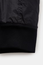 Close-up side view of the sleeve cuff on the Stone Island Jacket 'Garment Dyed Crinkle Reps NY' dark navy, showing the ribbed elastic cuff and microfibre fabric with creased resin coating.