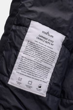 Close-up interior view of the Stone Island Jacket 'Garment Dyed Crinkle Reps NY' dark navy showing the white sewn-in label with fabric research and treatment details. Function meets style: This sporty jacket by STONE ISLAND is made of a lightweight microf