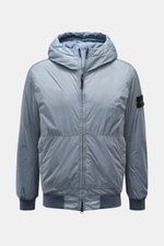Front view of the Stone Island Blouson 'Garment Dyed Crinkle Reps NY' rauchblau, a sporty lightweight microfiber jacket with a crinkled resin finish, padded hood, elastic cuffs and hem, two-way zipper, zipper pockets, and signature compass badge on the up