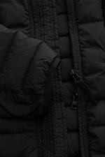 Close-up front view of the Stone Island Daunenjacke 'Seamless Tunnel Nylon Down-TC' schwarz, showing the smooth black microfiber fabric, slim fit design, lightweight duck down filling, garment-dyed texture, high collar, two-way zipper with wind flap and s