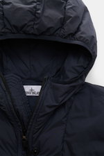 Close-up front view of Stone Island Daunenjacke 'Seamless Tunnel Nylon Down-TC' dark navy, showing hood, zipper, and nylon fabric with lightweight down fill, garment dyed, water-repellent, slim fit, elastic cuffs, and signature compass badge.