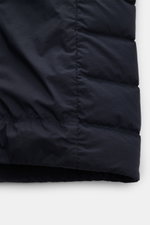 Close-up view of the hem and stitching details of the Stone Island Daunenjacke 'Seamless Tunnel Nylon Down-TC' dark navy, showcasing its high-quality microfiber, lightweight down filling, and water-repellent, garment-dyed fabric with elastic cuffs and adj