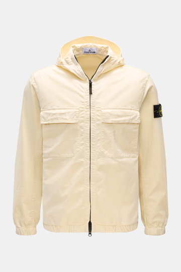 Front view of the Stone Island Blouson 'Stretch Cotton Twill-TC' creme, a slim fit spring jacket in elastic, soft cotton with garment dyed fabric, featuring a robust two-way zipper, hood with drawstring, chest patch pockets, side seam front pockets, and e