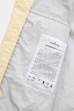Close-up inside view of the Stone Island Jacket 'Membrana' cream showing fabric label with details on its breathable, water repellent triple-layer fabric.

<p>Function meets style: The triple-layer functional fabric of this STONE ISLAND jacket is laminate