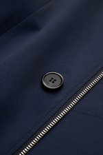 Close-up front view of the Mandelli Jacke navy showing navy pure new wool fabric, smooth texture, button with logo, and silver two-way zipper.