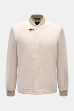 Front view of Fay Blouson beige, a slim fit jacket with rib knit collar and cuffs, two-way zip, storm flap with snap buttons, signature carabiner closure, slanted hip pockets, smooth lining, and one inside pocket, made from a luxurious blend of cotton, si