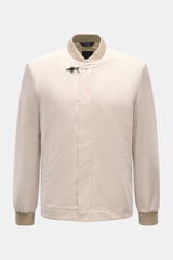 Front view of Fay Blouson beige, a slim fit jacket with rib knit collar and cuffs, two-way zip, storm flap with snap buttons, signature carabiner closure, slanted hip pockets, smooth lining, and one inside pocket, made from a luxurious blend of cotton, si