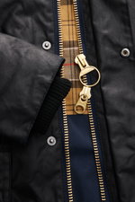Barbour Wachsjacke 'Bedale' dark navy, Nahaufnahme von Reißverschluss, Cord-Kragen und Tartan-Innenfutter, gewachste Baumwolle, Regular Fit.