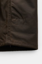 Close-up of the lower hem and stitching detail of the Barbour Waxed jacket 'Beaufort' dark olive, photographed from the front.

Description: A true classic from BARBOUR: The long waxed jacket 'Beaufort' made of water repellent, waxed cotton with corduroy 
