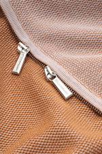 Close-up shot from above of the zipper area on the Moorer Cardigan 'Urbino' off-white/light brown mottled, showing the silver two-way zip with branded pulls and the medium-fine knit fabric with narrow contrasting borders.

<p>Confident layering: This MOOR