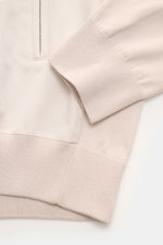 Close-up front-side view of the Moorer Jersey blouson 'Tolly' cream/beige showing twill trim, elastic cuff, zip pocket, and ribbed hem. Sporty and elegant for warm days: With a twill trim and the finest 'Sea Island' cotton, the jersey blouson by MOORER is