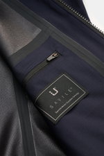 Close-up interior view of the UBR Blouson 'Bullet Savile' navy showing fine wool fabric, sealed seams, inside pocket with zip, and label. Minimalist and functional: With its ultra lightweight design and the fine wool fabric, this 'Bullet Savile' blouson f