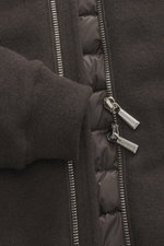 Close-up front view of the Moorer Down blouson 'Brigno' grey-brown melange showing soft virgin wool-cashmere knit, silver two-way zipper with branded pulls, and elastic rib cuff. High performance at temperatures from above freezing to below: The knitted d