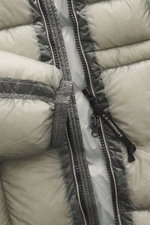 Close-up front view of C.P. Company Down jacket 'DD Shell' sage showing zipper, microfiber ripstop fabric, and padded quilting.

Description: <p>For the lightweight down jacket 'DD Shell', C.P. COMPANY uses durable ripstop fabric and high-quality padding 