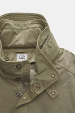 Close-up front view of C.P. Company Down jacket olive showcasing high-quality microfiber, removable down filling, regular fit, durable two-way zipper, wind flap with press studs, high collar with stowable hood, zipper front pockets, adjustable hem, cuff c