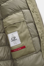 Close-up inside view of the C.P. Company Down jacket olive showing high-quality microfiber, removable down filling, regular fit, durable two-way zipper, wind flap with press studs, high collar with stowable hood, zipper front pockets, adjustable hem, cuff