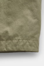Close-up front view of C.P. Company Down jacket olive made of high-quality microfiber with removable down filling, regular fit, durable two-way zipper, wind flap with press studs, high collar with stowable hood, zipper front pockets, adjustable hem, cuff 