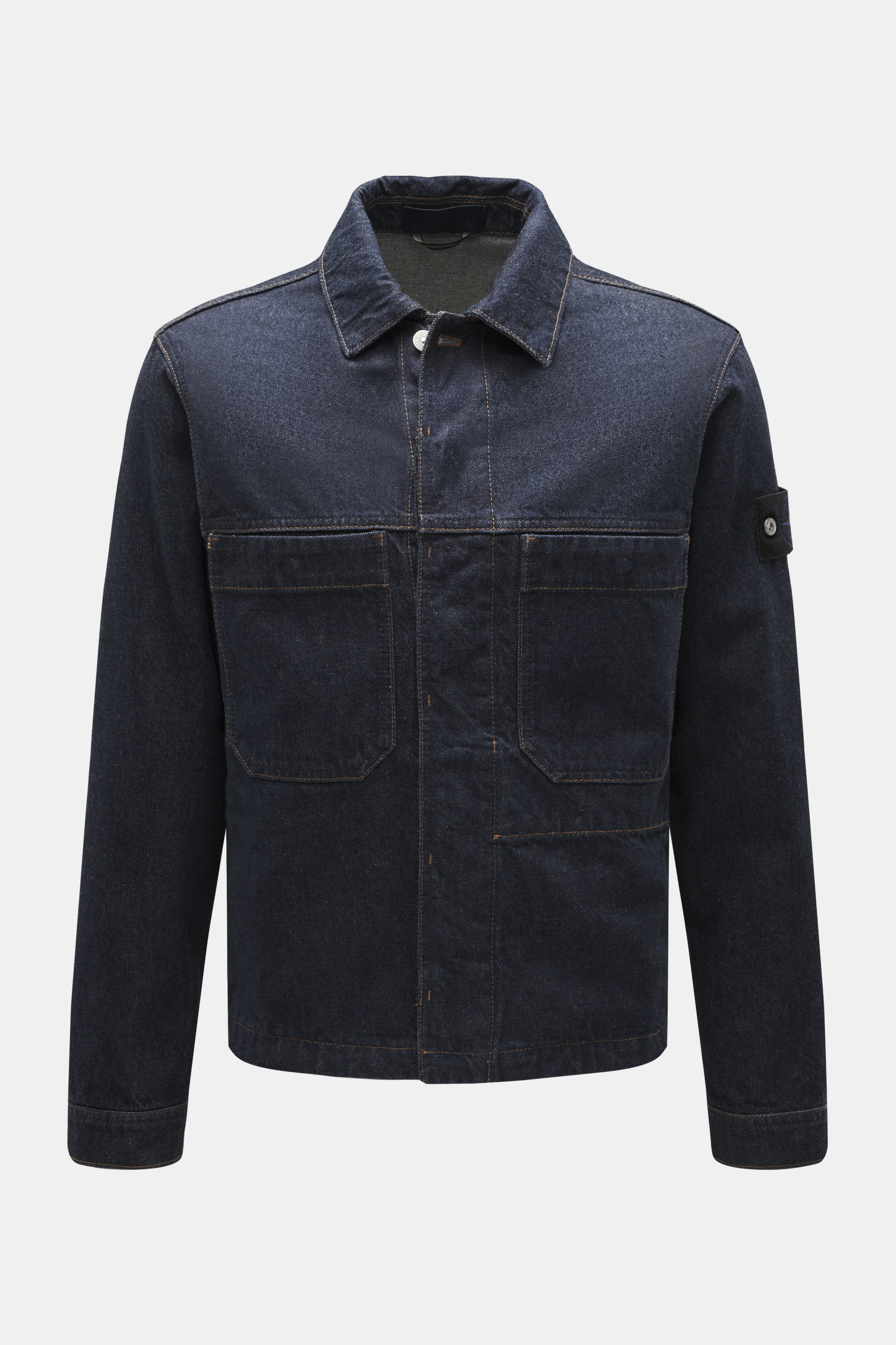 Front view of Stone Island Denim jacket 'Indigo Denim-Rinsed' dark blue in indigo-dyed pure cotton with typical fabric texture, slim fit, concealed button placket, turn-down collar, patch front pockets, button cuffs, and compass badge on the upper sleeve,
