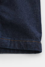 Close-up front view of Stone Island Denim jacket 'Indigo Denim-Rinsed' dark blue showing typical fabric texture, pure cotton denim, and orange stitching detail. For casual denim looks: This denim jacket in indigo-dyed cotton yarn from the 'Denim' capsule 
