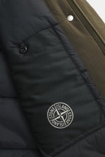 Nahaufnahme der Innenseite der Stone Island Jacke 'Stellina' oliv, zeigt hochwertige Microfaser, wasserabweisend, Slim Fit, praktische Kapuze, Zwei-Wege-Reißverschluss, verdeckte Zipper-Nahttaschen, dezentes Stellina-Stitching, verstellbare Saumweite, ges