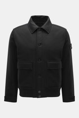 Front view of Stone Island Blouson 'Wool Nylon Flannel Ghost Piece' black, slim fit with six-button placket, turn-down collar, tonal badge on upper arm, buttoned sleeve cuffs, quilted lining fabric, one inside pocket, made of mix of virgin wool and microf