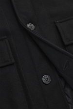 Close-up front view of Stone Island Blouson 'Wool Nylon Flannel Ghost Piece' black, showing six-button placket, turn-down collar, tonal badge on upper arm, buttoned sleeve cuffs, quilted lining fabric, one inside pocket, slim fit, soft feel, mix of virgin
