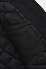 Close-up interior view of the Stone Island Blouson 'Wool Nylon Flannel Ghost Piece' black, showing quilted lining fabric, one inside pocket with button, and tonal badge, made from a mix of virgin wool and microfiber, with a soft feel, slim fit, six-button