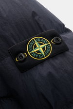 Close-up view of the Stone Island Down jacket 'Garment Dyed Crinkle Reps NY' dark navy showing the signature compass badge on high-quality crinkle microfibre coated fabric with garment-dyed look, wind and water repellent features.