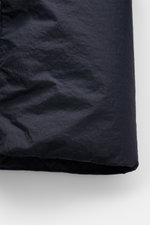 Close-up front view of the Stone Island Down jacket 'Garment Dyed Crinkle Reps NY' dark navy showing innovative coated crinkle microfibre fabric with garment-dyed look, lightweight, wind and water repellent features, warm down lining, and tonal lining.