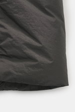 Stone Island Down jacket 'Garment Dyed Crinkle Reps NY' grey green close-up of innovative coated microfibre fabric texture, photographed from the side, highlighting lightweight, wind and water repellent qualities with a crinkle look and garment-dyed finis