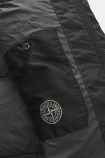 Close-up front detail of Stone Island Down jacket 'Garment Dyed Crinkle Reps NY' grey green, showing textured coated fabric, zip, and logo badge.

Description: <p>Innovative coated material in a signature garment-dyed look meets modern outdoor style in th