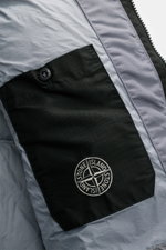 Close-up interior view of Stone Island Down jacket 'Garment Dyed Crinkle Reps NY' grey showing black branded pocket and light grey crinkle fabric.

<p>Innovative coated material in a signature garment-dyed look meets modern outdoor style in the down jacke