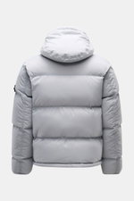 Stone Island Down Jacket 'Matt Ripstop Cordura' Smoky Blue shown from the back, featuring a detachable hood, elastic cuffs, and padded design. Technical performance in urban design: The down jacket 'Matt Ripstop Cordura' from STONE ISLAND impresses with r