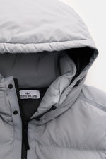 Close-up front view of Stone Island Down Jacket 'Matt Ripstop Cordura' Smoky Blue hood, showing high-quality microfiber, soft touch, water-repellent ripstop material, two-way zipper, and smooth lining fabric.

Description: <p>Technical performance in urba