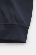 Close-up front view of the ribbed cuff and smooth microfiber fabric of the Stone Island Softshell Blouson 'Light Soft Shell-R e.dye Technology' navy, elastic, breathable, wind- and water-repellent with robust zipper.