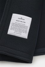 Close-up view of the Stone Island Pea Coat Navy showing the heavy melton fabric label on the felted surface made of fine virgin wool with cashmere blend. <p>This pea coat by STONE ISLAND features a felted surface made of fine virgin wool with a cashmere b
