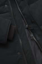 Close-up view of the Canada Goose Down jacket 'Wyndham' black showing the high-closing two-way zipper, wind flap with snap buttons, and comfortable windproof cuffs made from a mix of high-quality microfiber and cotton with a smooth feel, warm down filling