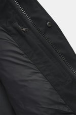 Close-up view of the Canada Goose Down jacket 'Wyndham' black, showing the high-closing two-way zipper, wind flap with snap buttons, and smooth microfiber and cotton fabric with warm down filling, smooth lining, and zippered welt pocket.