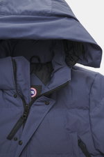 Close-up front view of Canada Goose Down jacket 'Wyndham' grey blue showing padded hood with drawstring, high-closing two-way zipper, wind flap with snap buttons, mix of high-quality microfiber and cotton, smooth feel, warm down filling, slim fit, four we