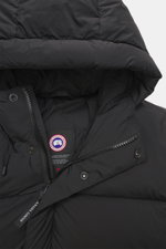 Close-up front view of the Canada Goose Down jacket 'Sterling' black, showcasing the quilted hood with drawstring, high-quality microfiber, smooth touch, water-repellent fabric, warm down filling, high-closing two-way zipper, wind flap with snap buttons, 
