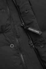 Close-up front view of the Canada Goose Down jacket 'Sterling' black showing high-quality microfiber, smooth touch, water-repellent fabric, warm down filling, oversized fit, high-closing two-way zipper, wind flap with snap buttons, quilted hood with draws