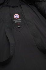 Canada Goose Down jacket 'Sterling' black inside view showing high-quality microfiber, smooth touch, water-repellent fabric, warm down filling, oversized fit, high-closing two-way zipper, wind flap with snap buttons, quilted hood with drawstring, large we